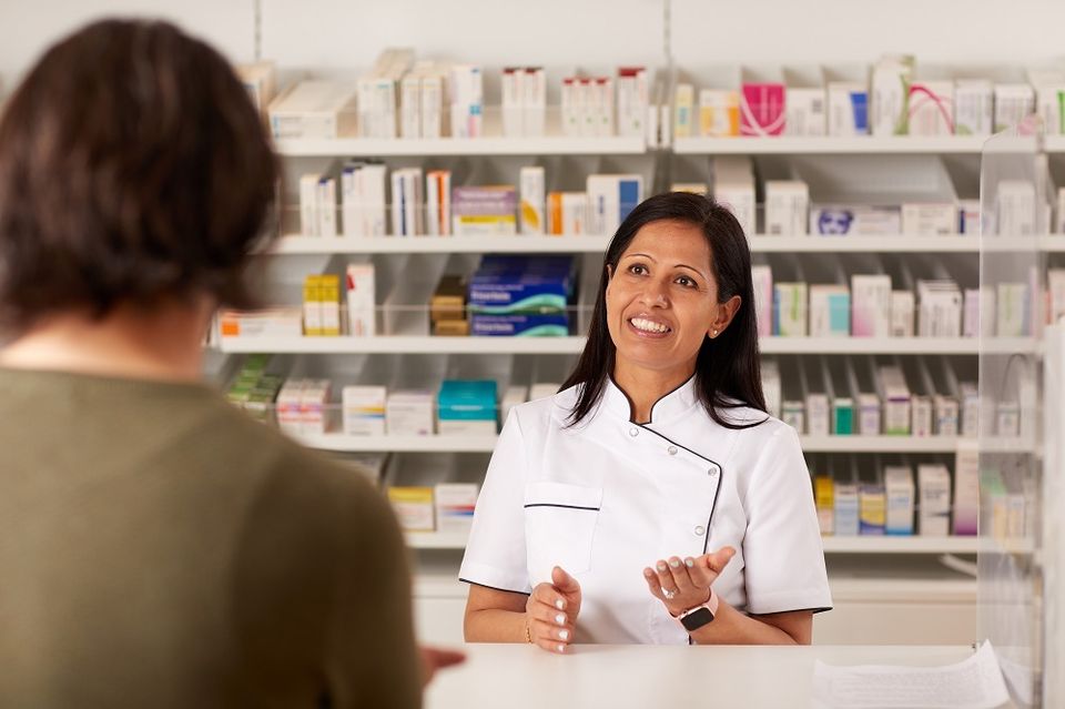 Female pharmacist talking to a patient